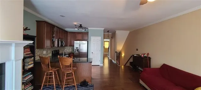 a living room with lots of furniture and kitchen view