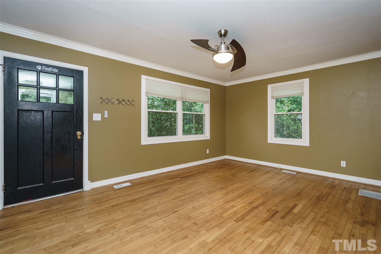 804 Sasser Street Raleigh, NC 27604 - Photo 3 of 15 a view of an empty room with wooden floor and a window