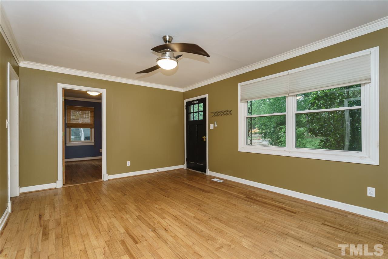 804 Sasser Street Raleigh, NC 27604 - Photo 4 of 15 a view of an empty room with a window and wooden floor