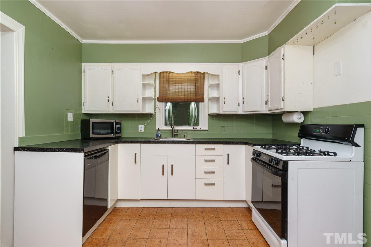 804 Sasser Street Raleigh, NC 27604 - Photo 6 of 15 a kitchen with granite countertop a stove top oven microwave and cabinets