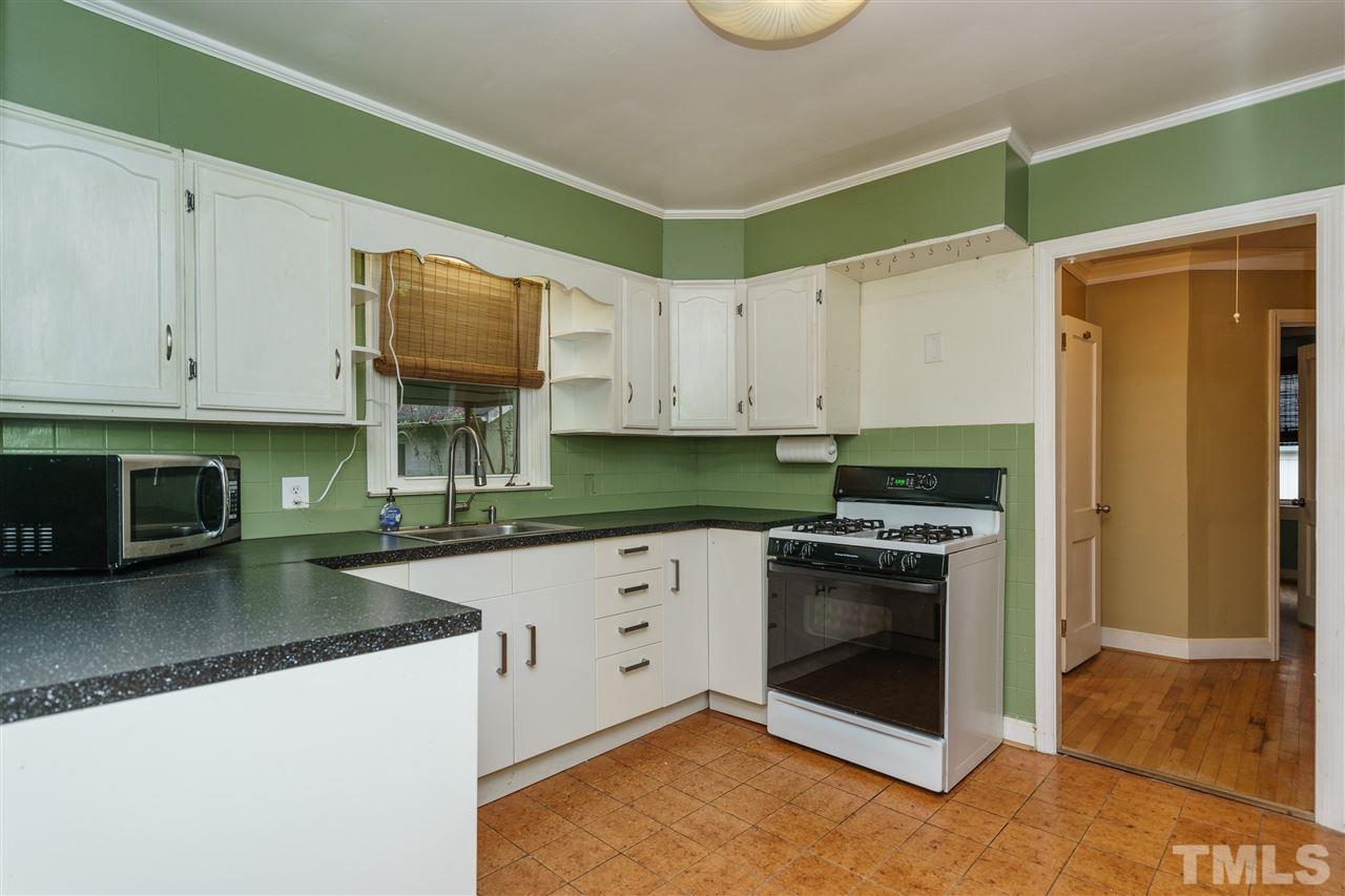 804 Sasser Street Raleigh, NC 27604 - Photo 8 of 15 a kitchen with granite countertop a stove sink and cabinets