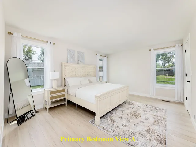 a bedroom with a bed chair and a window