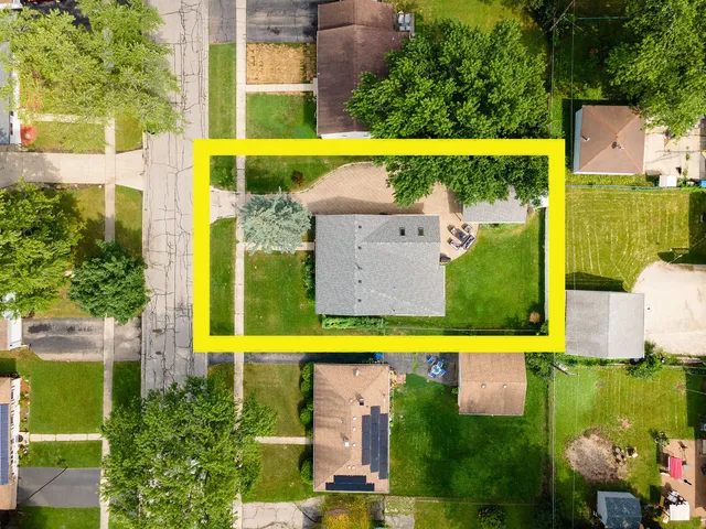 an aerial view of a house with a swimming pool