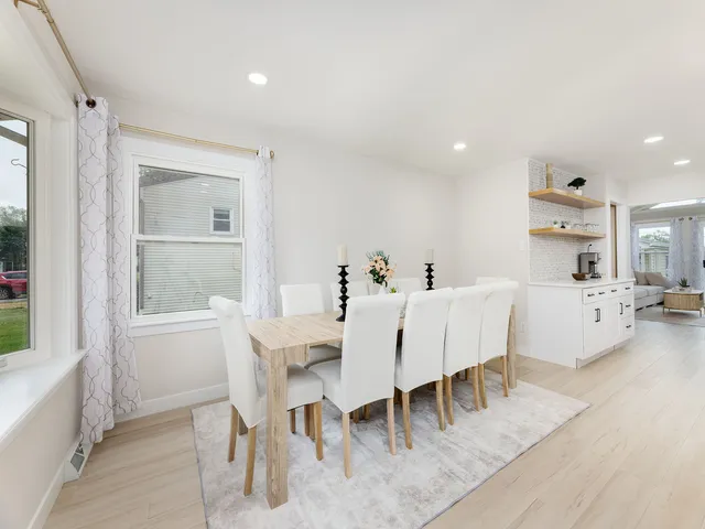 a view of a dining room with furniture and window