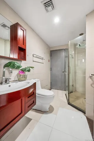 a bathroom with a sink mirror and shower