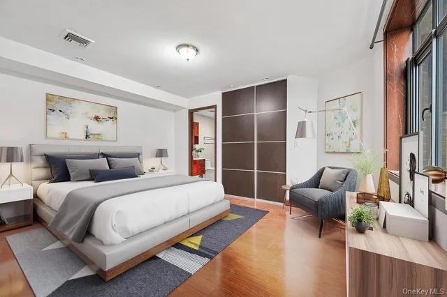 a bedroom with furniture and a potted plant