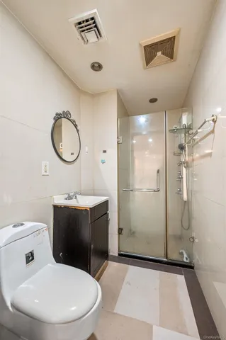a bathroom with a toilet sink shower and mirror