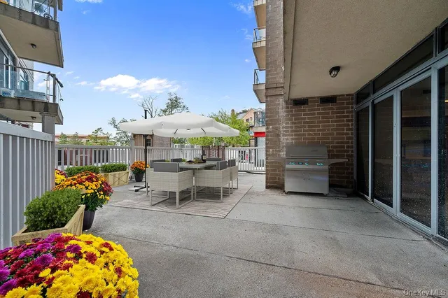 a view of a patio with table and chairs and potted plants