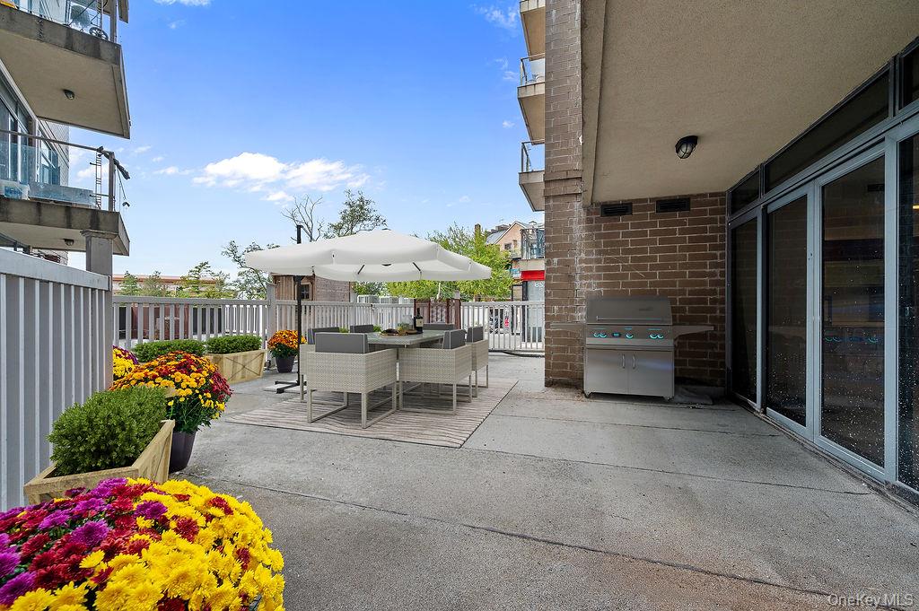 132-29 Blossom Avenue, Unit 2G Queens, NY 11355 - Photo 9 of 10 a view of a patio with table and chairs and potted plants