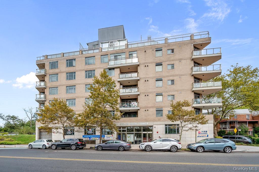 132-29 Blossom Avenue, Unit 2G Queens, NY 11355 - Photo 10 of 10 a city street with tall buildings and cars parked in front of it