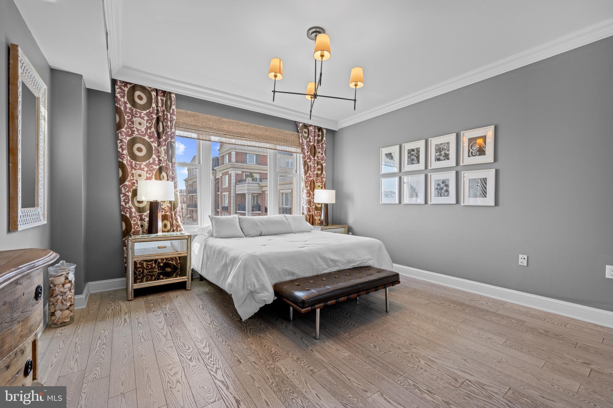 801 Key Highway, Unit 458 Baltimore, MD 21230 - Photo 29 of 48 a bedroom with a bed wooden floor and window