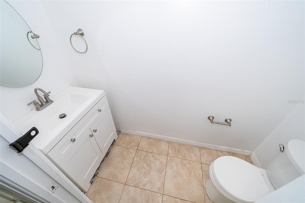 3135 Enclave Court Kissimmee, FL 34746 - Photo 17 of 22 a bathroom with a sink and mirror