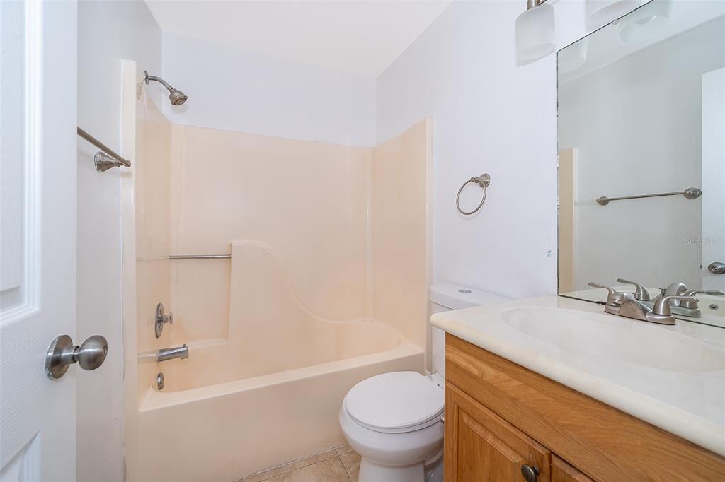 3135 Enclave Court Kissimmee, FL 34746 - Photo 20 of 22 a bathroom with a granite countertop sink toilet and shower
