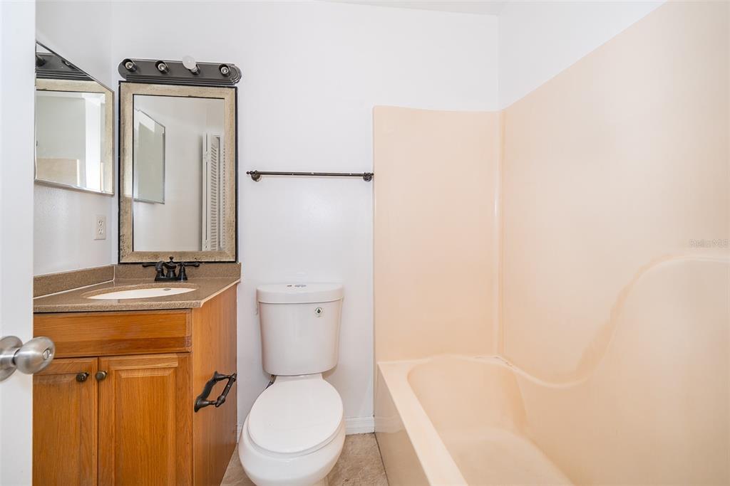 3135 Enclave Court Kissimmee, FL 34746 - Photo 21 of 22 a white toilet sitting next to a bathroom sink