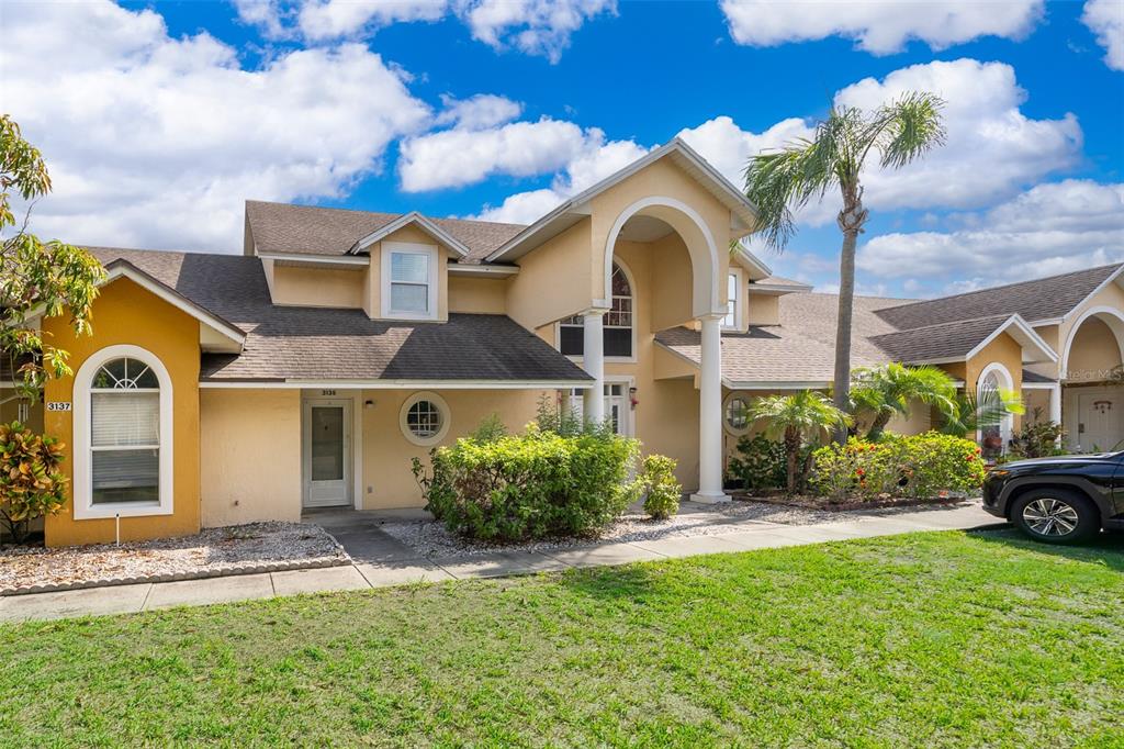 3135 Enclave Court Kissimmee, FL 34746 - Photo 3 of 22 a front view of a house with a garden