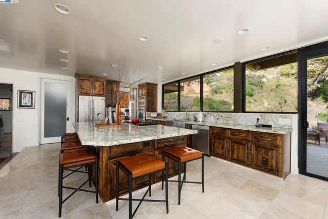 a dining room with furniture and large windows
