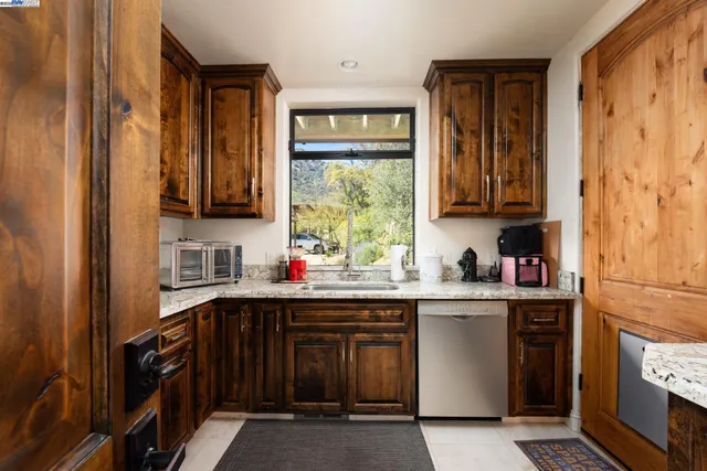 a utility room with stainless steel appliances washer and dryer