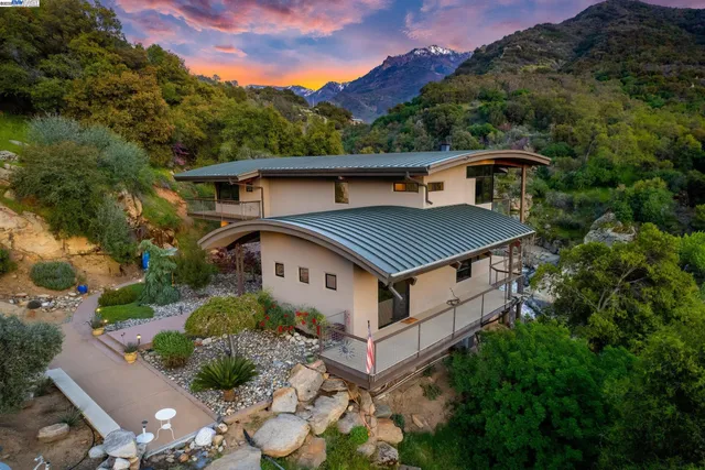 a view of a balcony with chairs and wooden floor