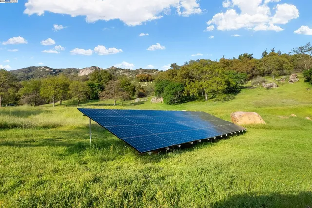 a view of a dining room with furniture large windows and wooden floor
