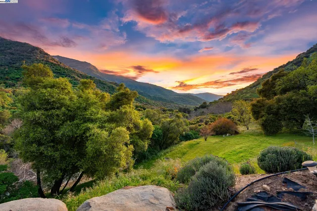 a bedroom with a bed next to a window