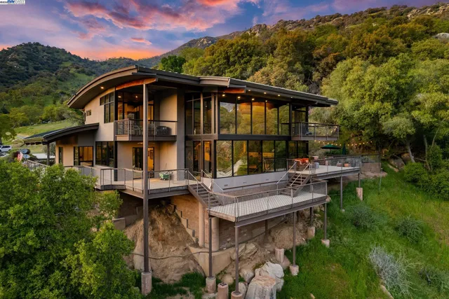 a view of house with backyard and outdoor seating