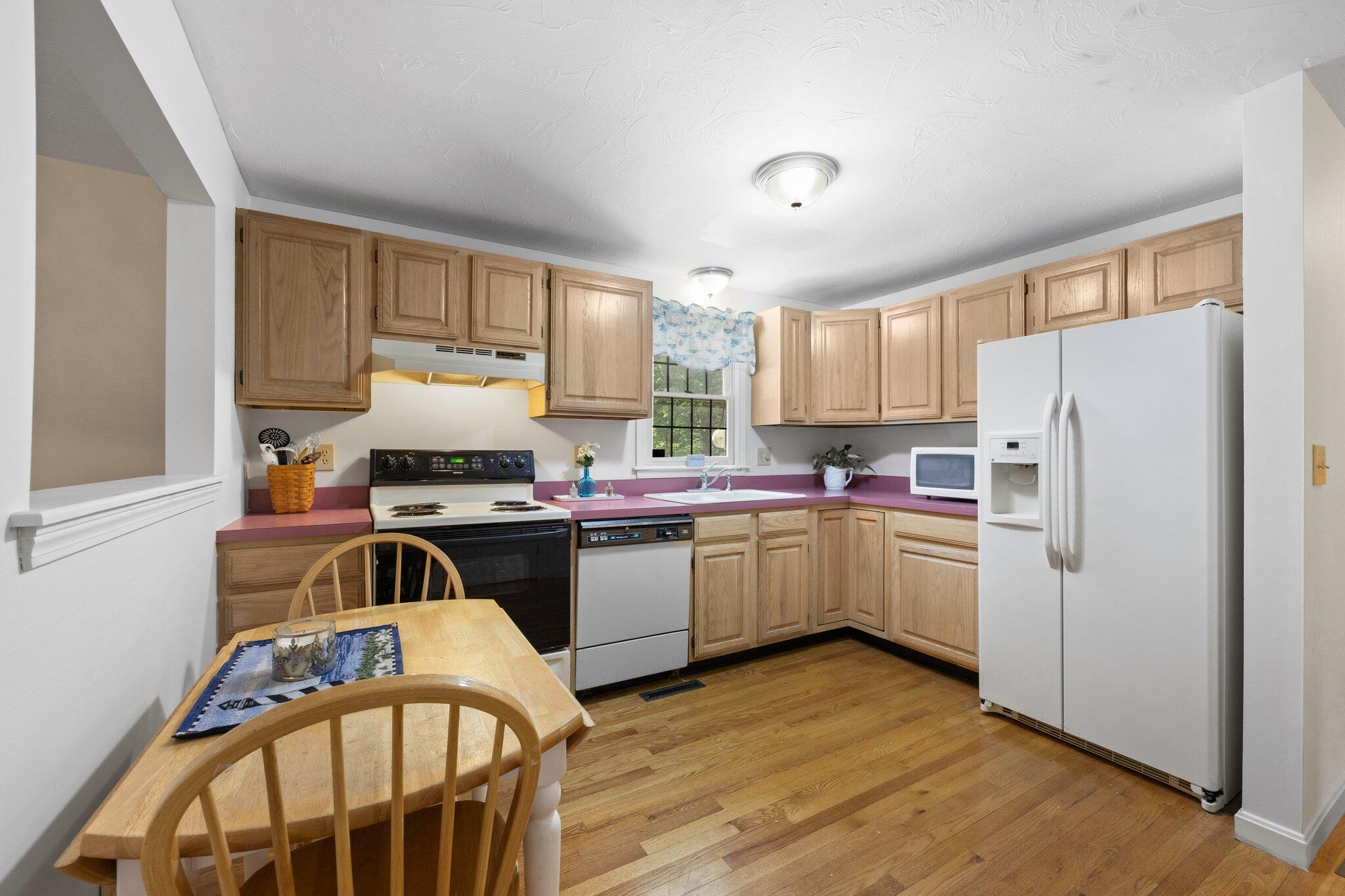 145 Braley Jenkins Road Centerville, MA 02632 - Photo 12 of 33 a kitchen with a refrigerator a stove a sink dishwasher and a stove with wooden floor