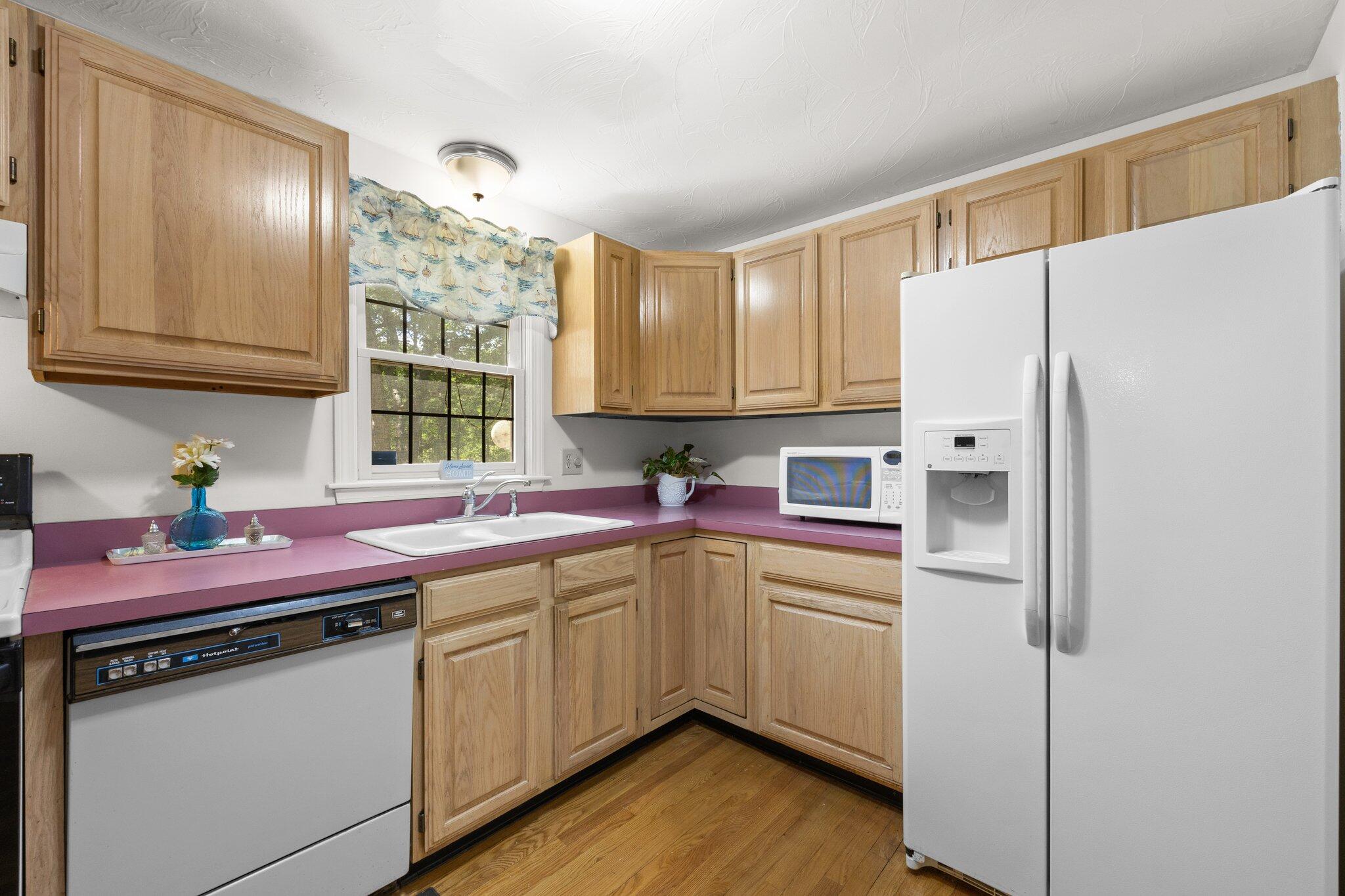 145 Braley Jenkins Road Centerville, MA 02632 - Photo 13 of 33 a kitchen with a sink cabinets and window