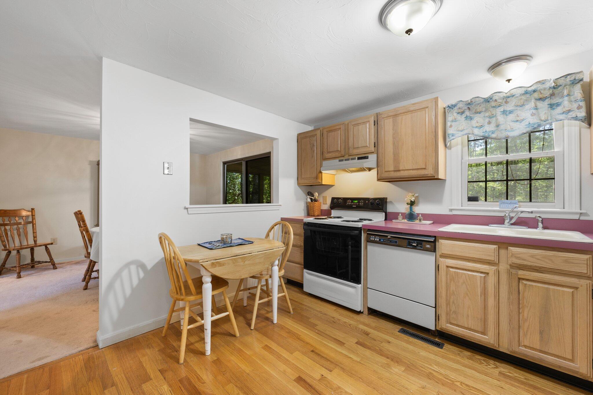 145 Braley Jenkins Road Centerville, MA 02632 - Photo 14 of 33 a kitchen with a table chairs sink and cabinets
