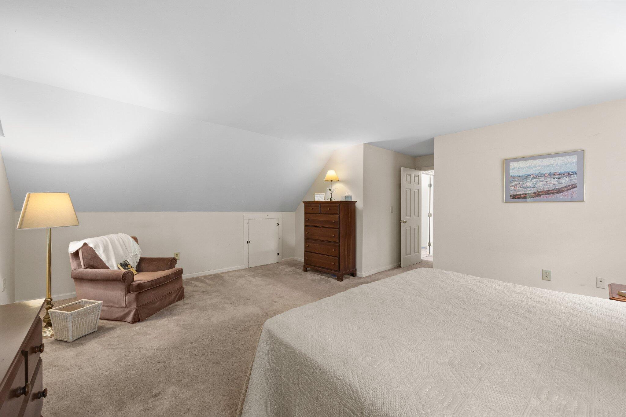 145 Braley Jenkins Road Centerville, MA 02632 - Photo 19 of 33 a bedroom with a bed and a lamp