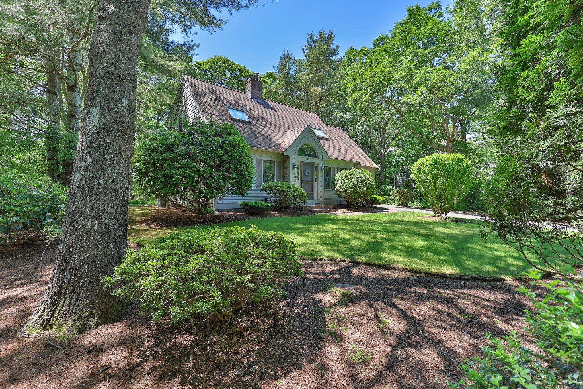 145 Braley Jenkins Road Centerville, MA 02632 - Photo 2 of 33 a front view of a house with garden
