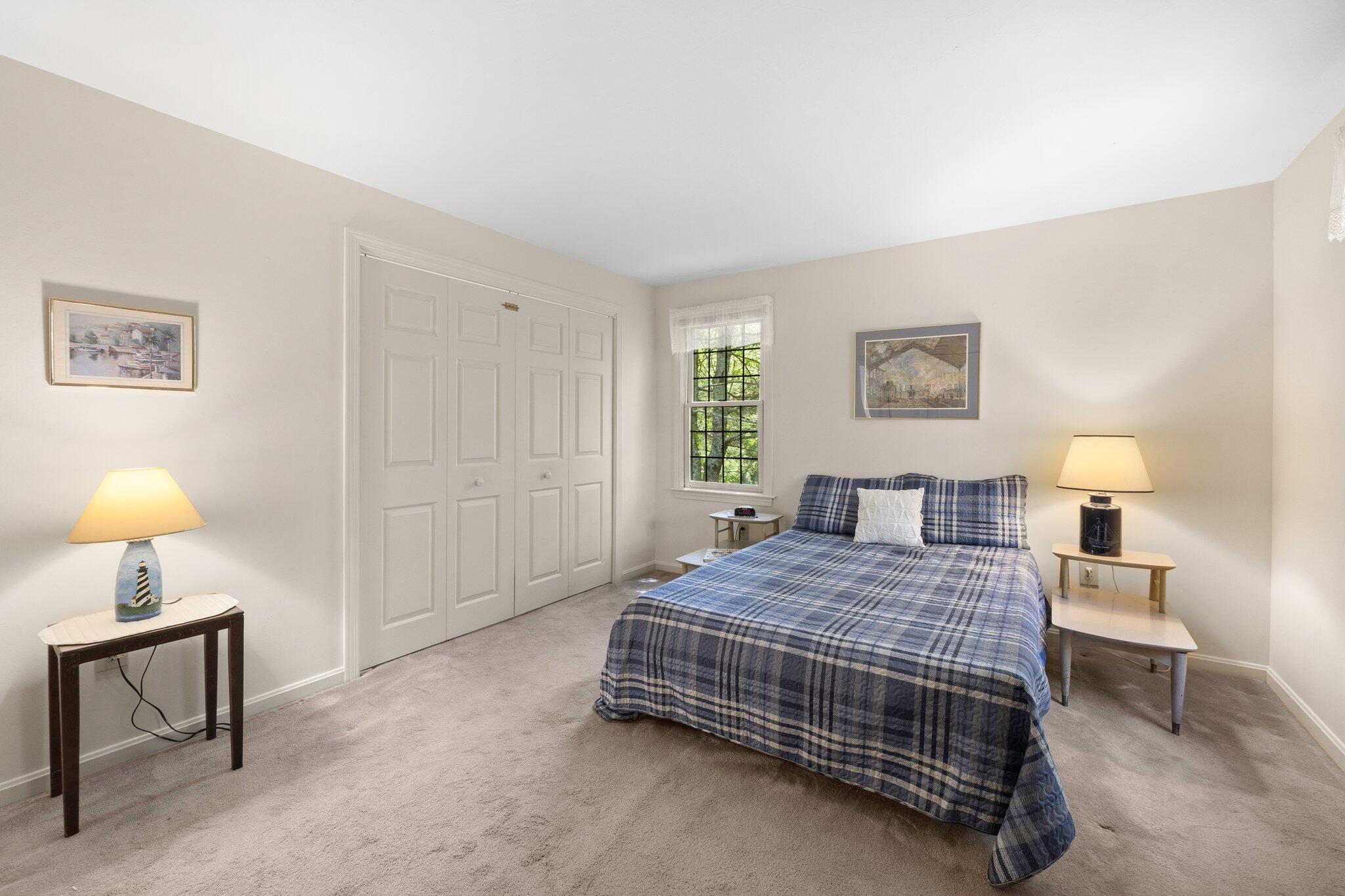 145 Braley Jenkins Road Centerville, MA 02632 - Photo 21 of 33 a bedroom with a bed a lamp and a window