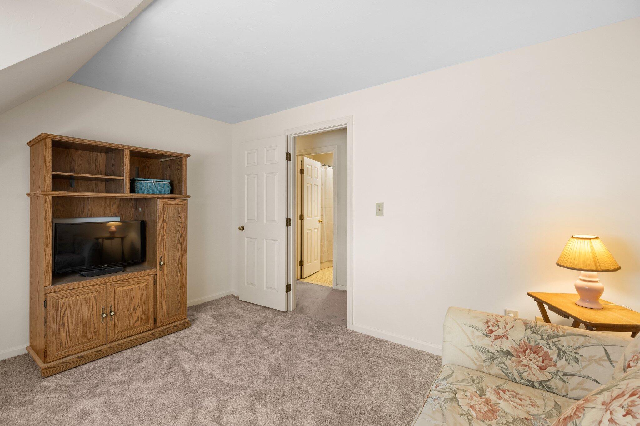 145 Braley Jenkins Road Centerville, MA 02632 - Photo 26 of 33 a bedroom with a bed and a television