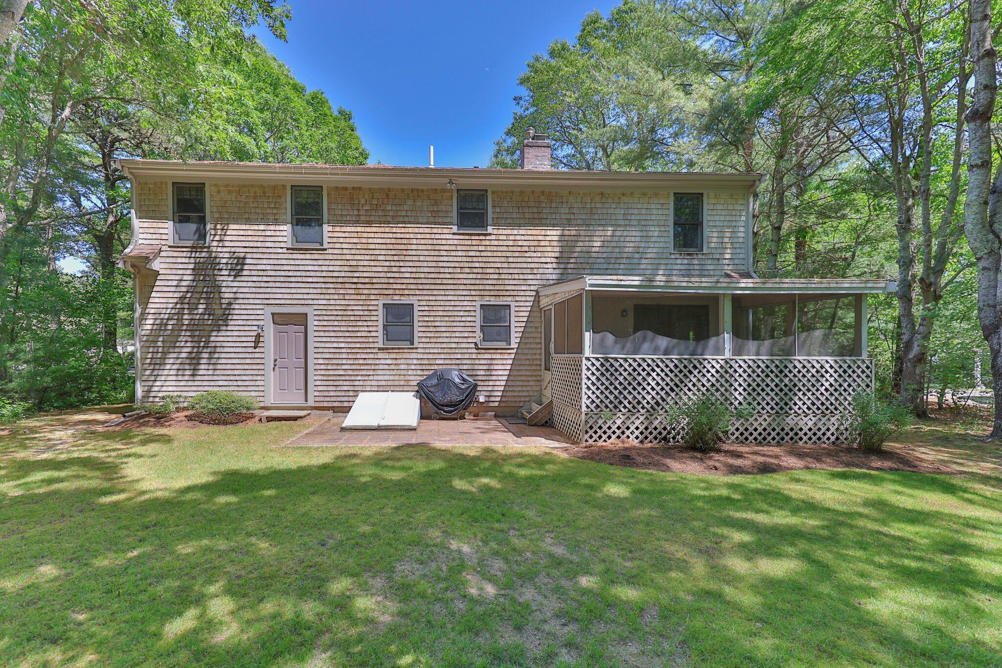 145 Braley Jenkins Road Centerville, MA 02632 - Photo 30 of 33 a front view of a house with a garden