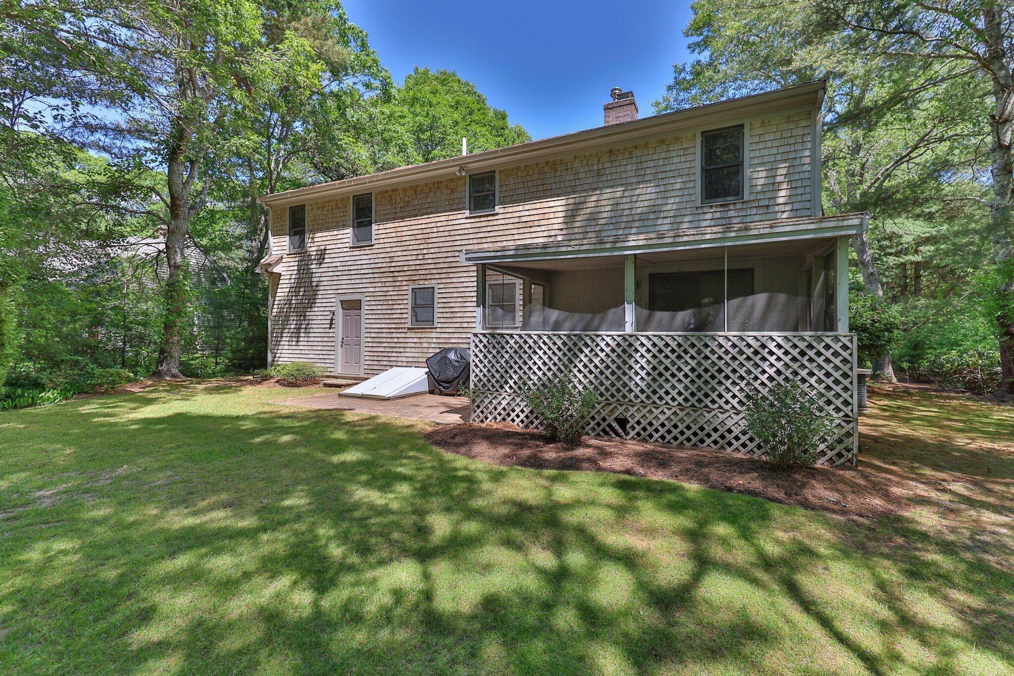 145 Braley Jenkins Road Centerville, MA 02632 - Photo 31 of 33 a front view of a house with a garden