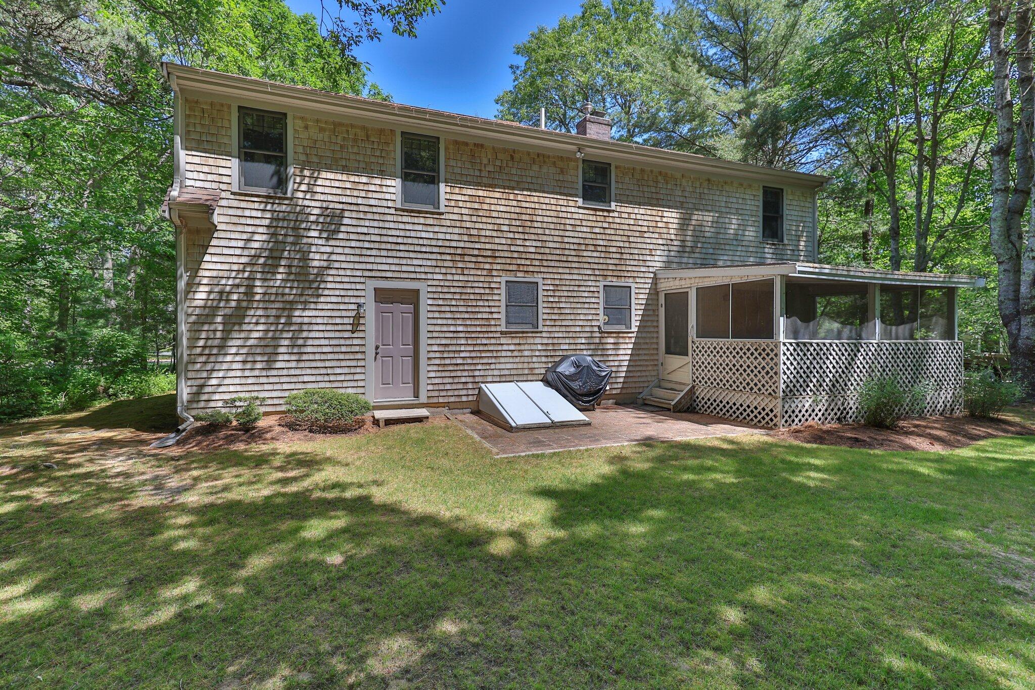 145 Braley Jenkins Road Centerville, MA 02632 - Photo 32 of 33 a view of a house with backyard and furniture