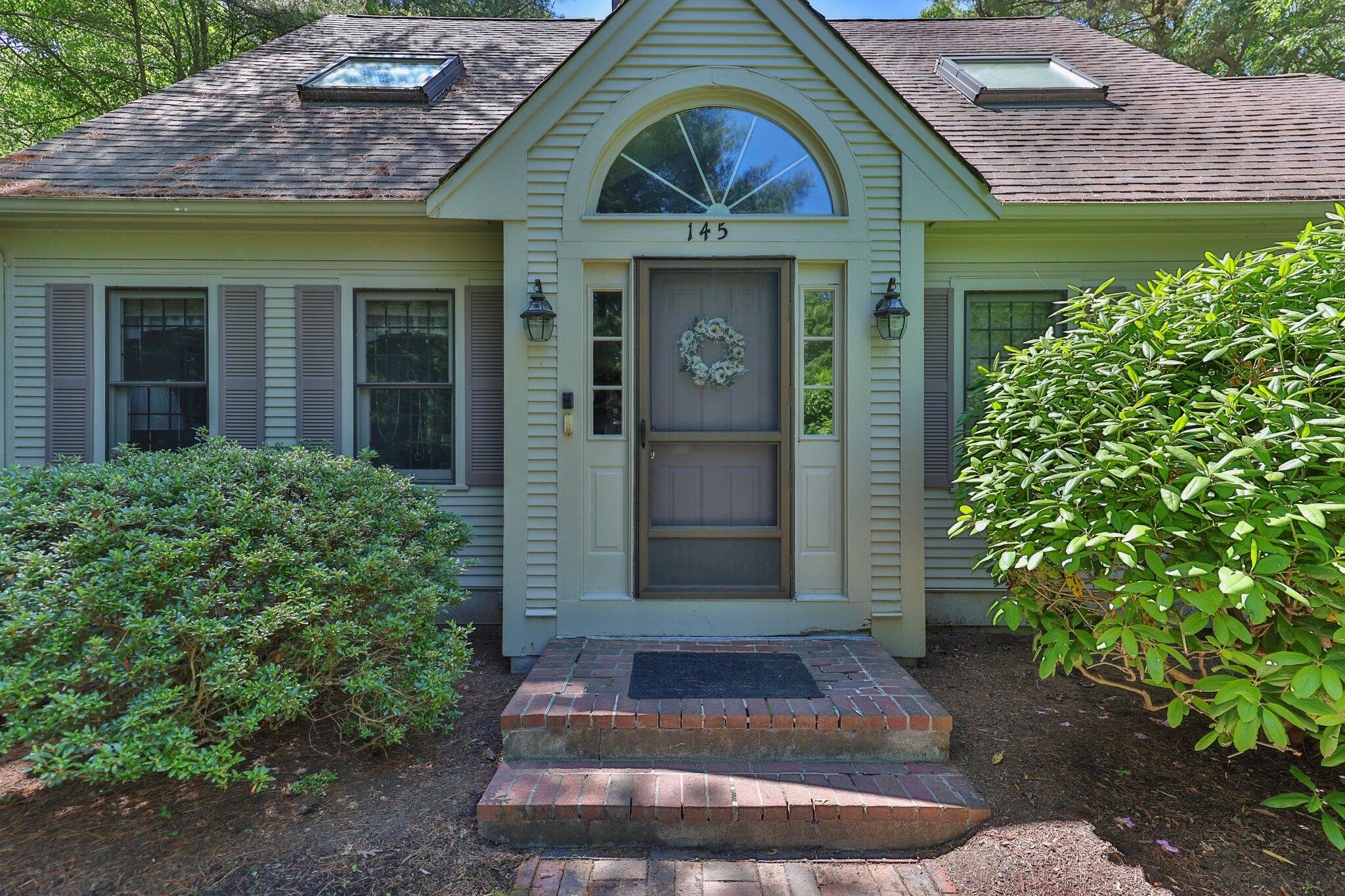 145 Braley Jenkins Road Centerville, MA 02632 - Photo 4 of 33 a view of a brick house with plants