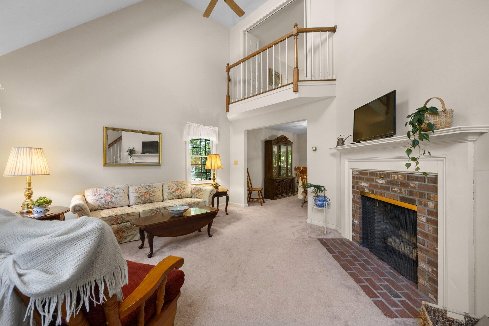 145 Braley Jenkins Road Centerville, MA 02632 - Photo 7 of 33 a living room with furniture a fireplace and a flat screen tv
