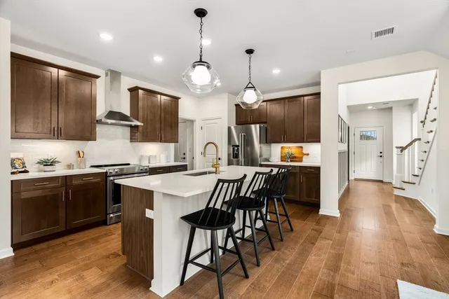 a kitchen with stainless steel appliances kitchen island granite countertop a sink and cabinets