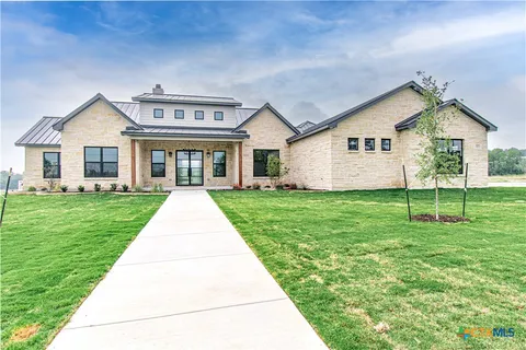 a front view of house with yard and green space