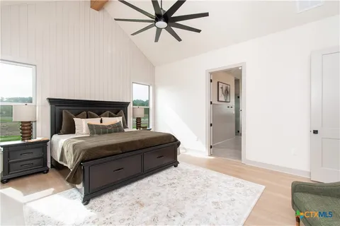 a bedroom with a bed lamp and a window