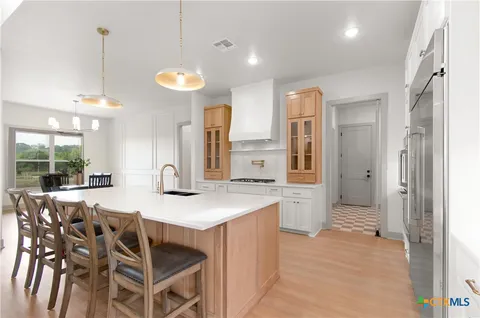 a large kitchen with a table and chairs