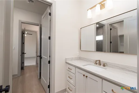 a bathroom with a granite countertop sink mirror and double