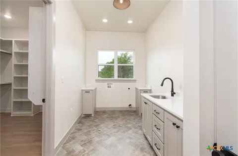 a bathroom with a double vanity sink a window and a mirror