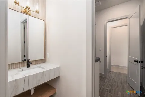 a bathroom with a sink a mirror and a bathtub