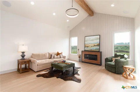 a living room with furniture fireplace and flat screen tv