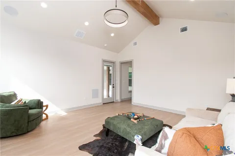 a living room with furniture and a wooden floor