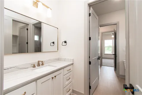 a bathroom with a granite countertop sink mirror and double