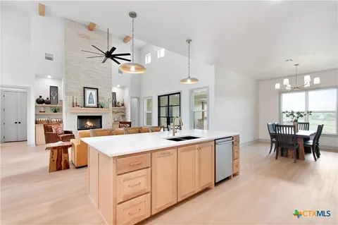 a view of a kitchen and a dining table with chairs