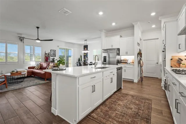 a kitchen with stainless steel appliances a sink and a refrigerator
