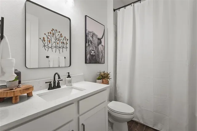 an aerial view of a house with a yard basket ball court